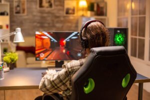 back view gamer male playing shooter