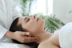lying woman receiving massage craniosacral therapy