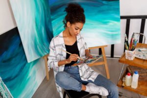 professional female artist painting canvas studio
